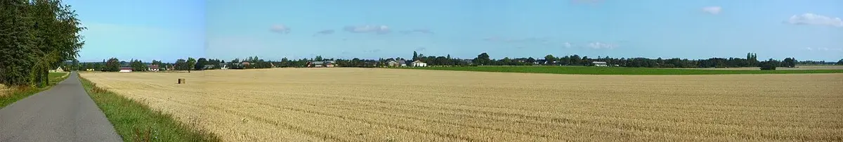 Panoramic view of Frejlev, Denmark, across open fields.