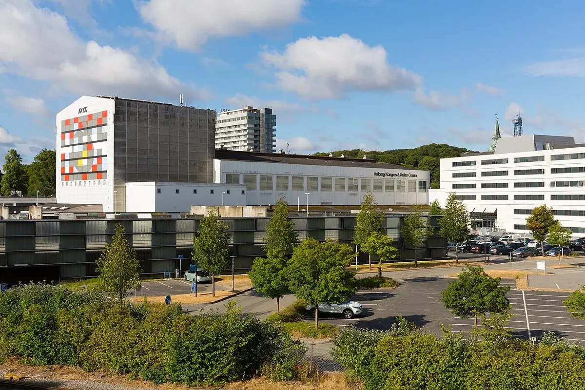 Aalborg Kongres & Kultur Center seen from across a parking area in Aalborg.