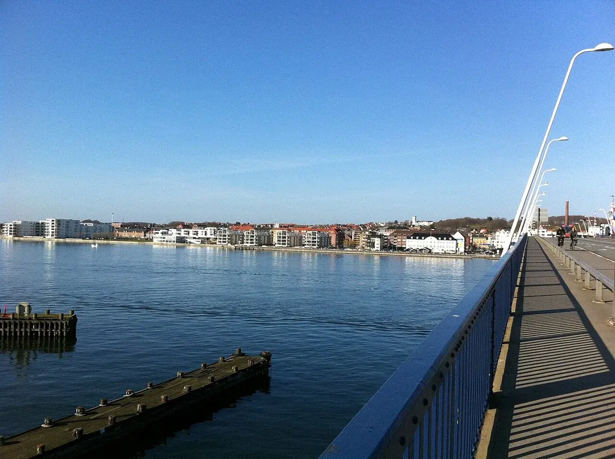 View of Nørresundby across the fjord from a bridge walkway.