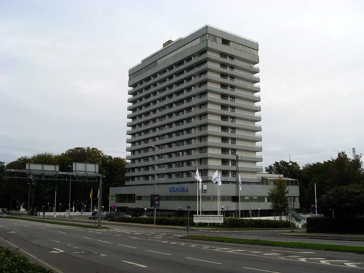 A tall hotel building beside a road in Aalborg, Denmark.